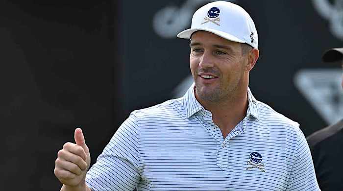 Bryson DeChambeau interacts with fans while warming up during the first round of the 2023 LIV Golf Chicago golf tournament at Rich Harvest Farms